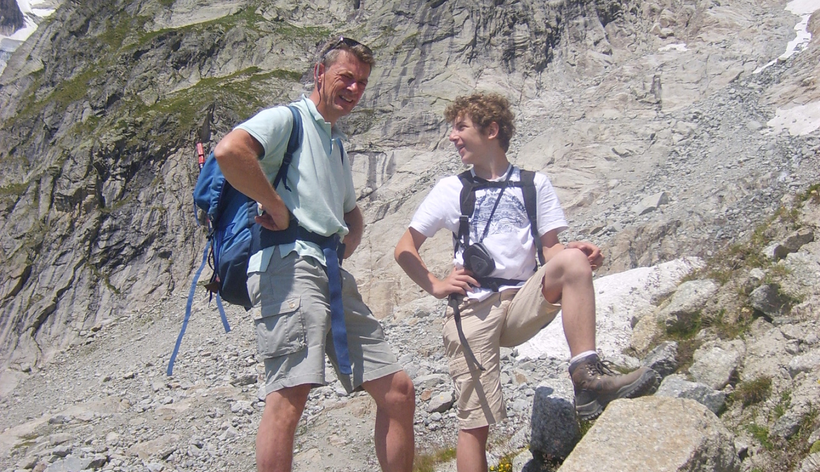 een vader en zoon poseren op een berg voor een foto