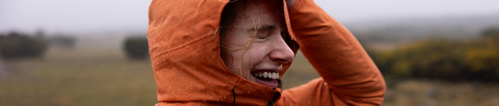 vrouw met capuchon in regen